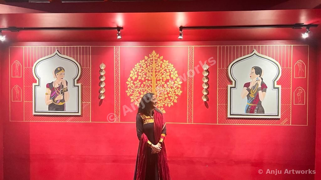 Red wall mural with golden tree and framed artworks at Restaurant Exotica